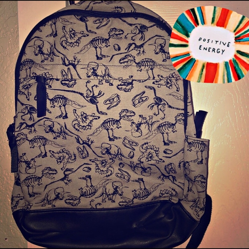 A black and gray dinosaur backpack